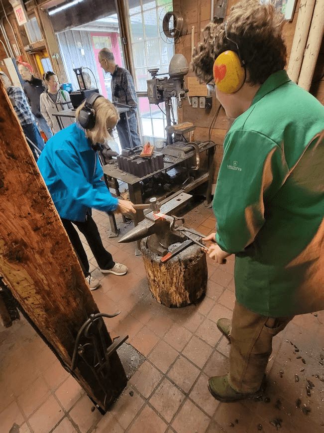 people trying hammering on anvil